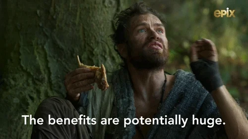 A man eating bread in a cave saying, 'The benefits are potentially huge.'
