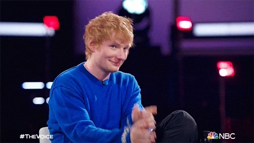 Ed Sheeran smiling and pointing