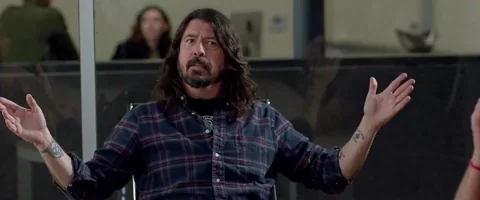 Dave Grohl points to his head and says, 