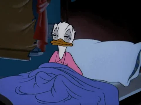 Donal Duck tucking himself into bed.