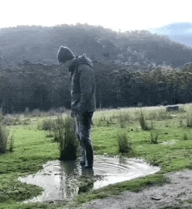 Man attempting a back flip in puddle and falling on his face. 