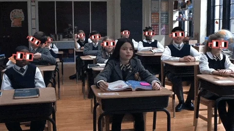 A girl raises her hand in a class 