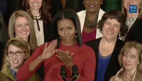 Michelle Obama doing the 'make it rain' gesture.
