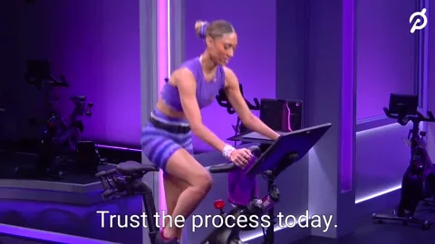 Gif of Ally Love riding a Peloton coaching riders to trust the exercise process