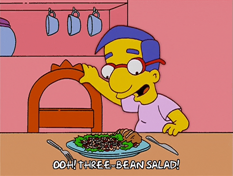 Milhouse from 'The Simpsons' sitting down at the table to eat and saying 'Ooh! Three-bean salad!'