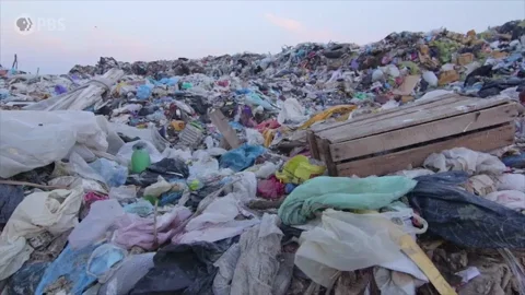 A gif of a garbage site with lots of plastic waste.