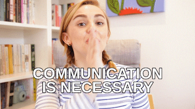 A woman in an office saying, 'Communication is necessary.'