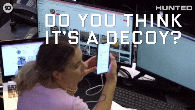 A woman shows someone a phone and asks,