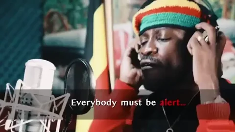 A reggae musician in a studio. He sings: 