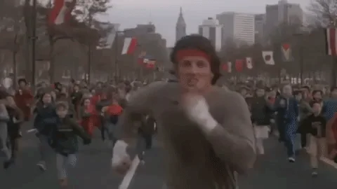 Rocky running through the streets of Philadelphia, very fast. 