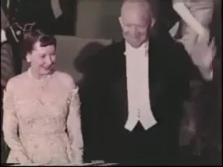 President Eisenhower and his wife, Mamie, smiling and waving.