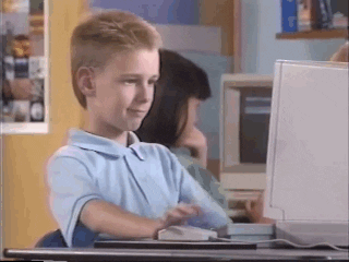 Kid looking at computer, then giving a thumbs up