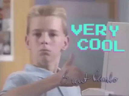 A young student giving a thumbs up in front of a computer. The text reads, 