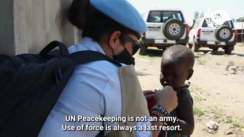 Peackeepers attend to civilians in a village. The narrator explains that 