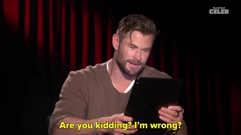 chris hemsworth using a tablet, on screen text: 