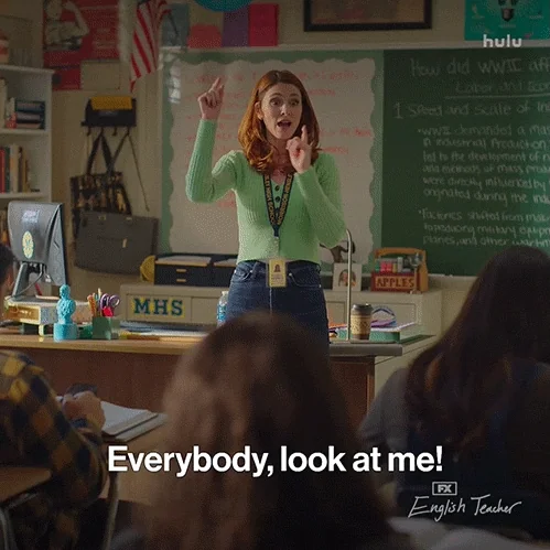A teacher telling her students, "Everybody, look at me!"