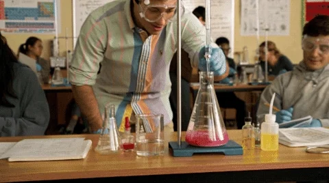 A student dabs while doing a science experiment in a school lab.