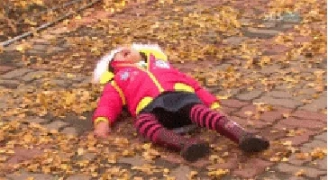 child laying on ground crying, waving her arms and kicking her legs