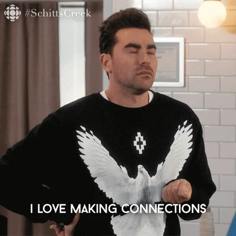 A man wearing a black sweater do a slight shimmy while say I love making connections. 