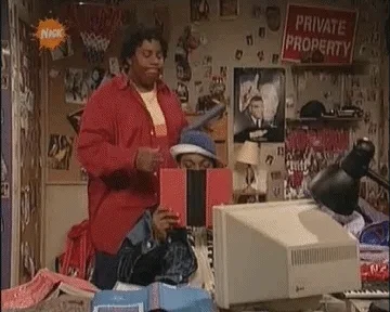 Kel Mitchell reading a book upside down and Kenan Thompson flipping it over.