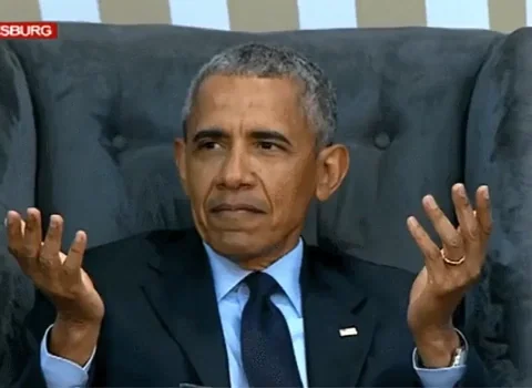 Barack Obama gesturing his hands and with a questioning facial expression. 