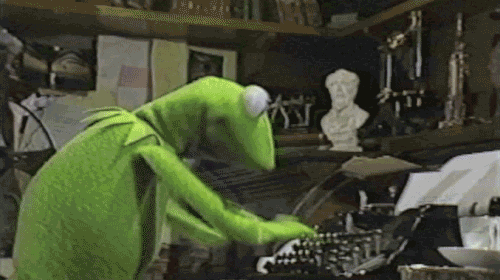 Kermit the frog typing furiously on a typewriter