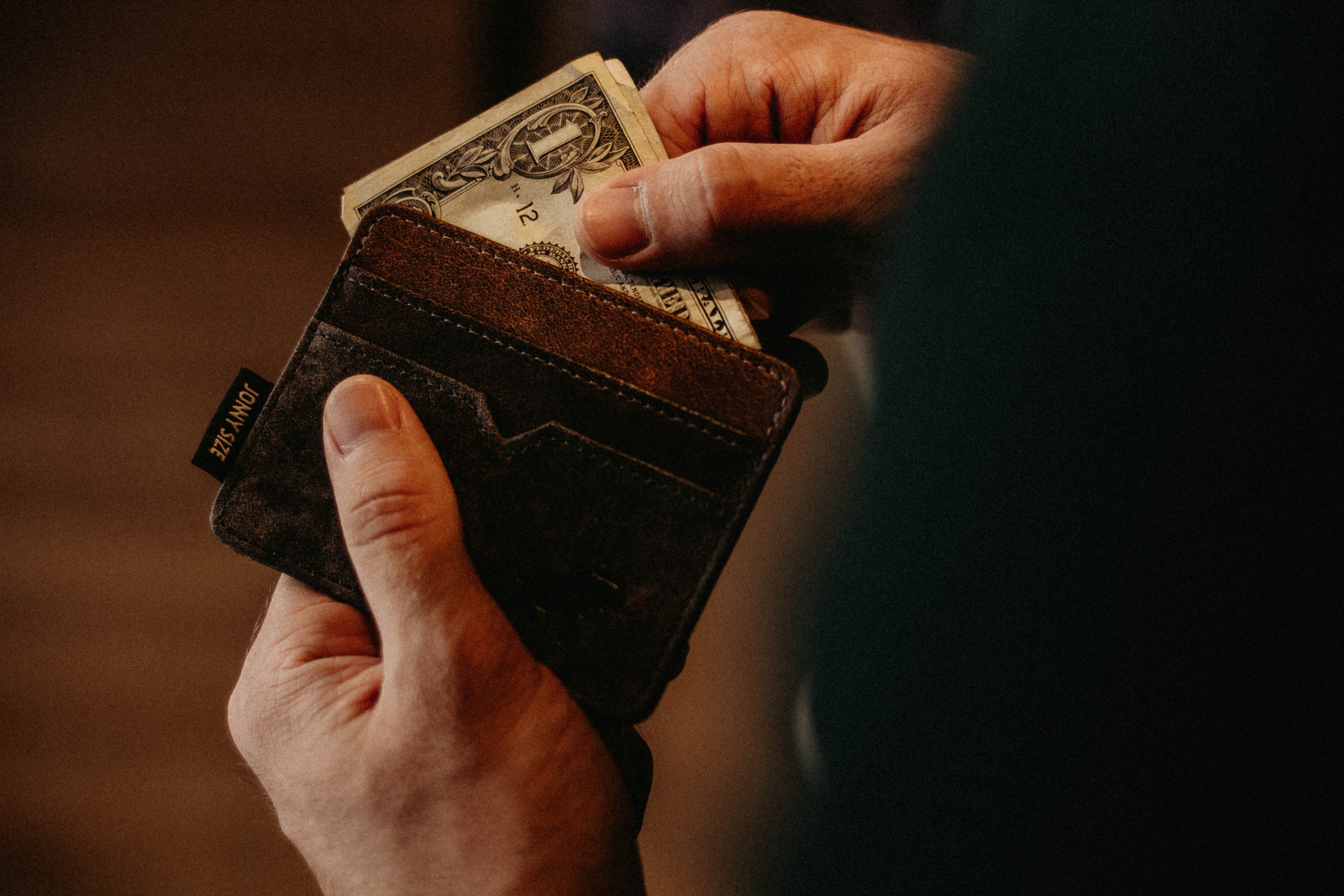 Person taking money out of his wallet.