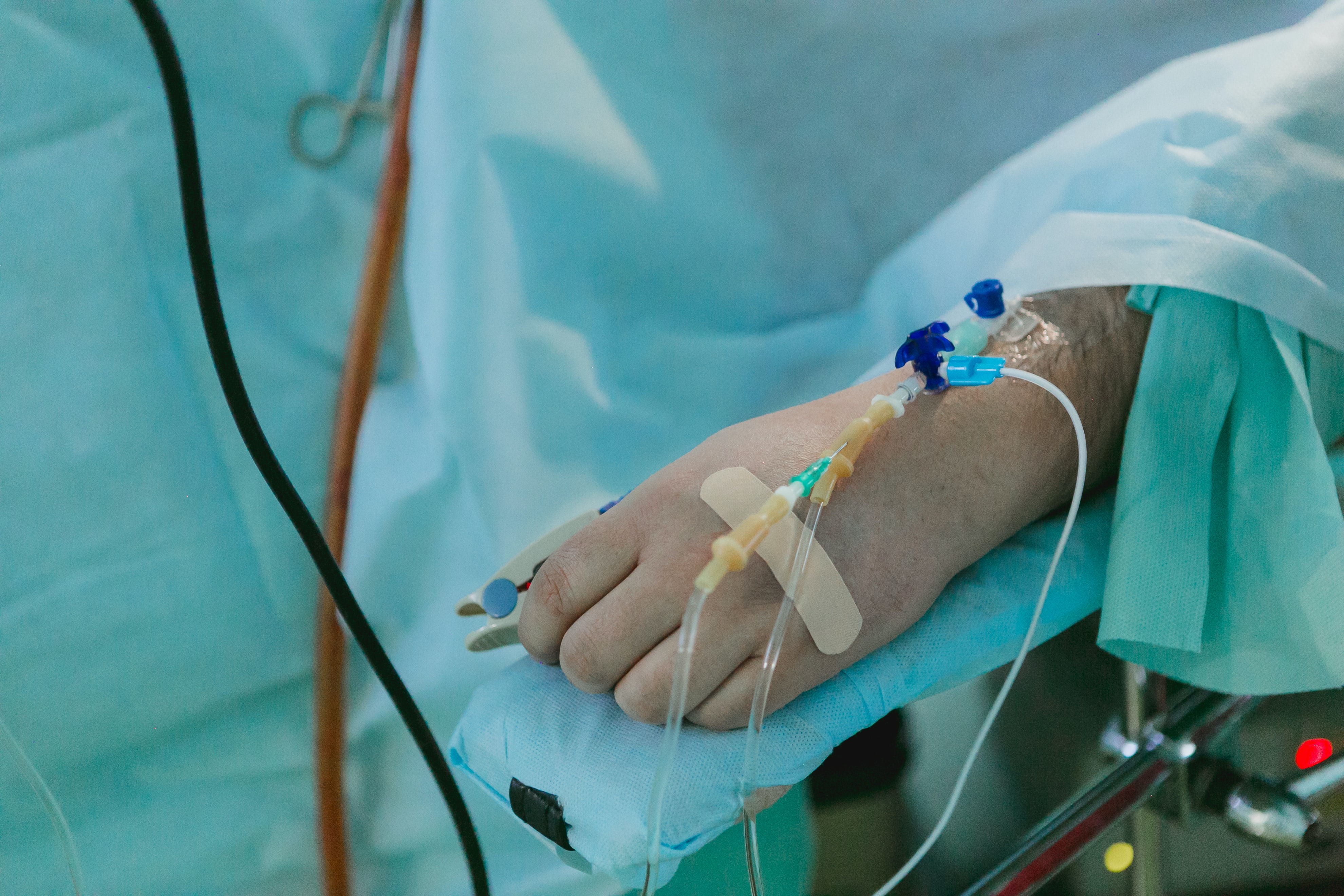 A hospital patient with an IV line inserted into their hand