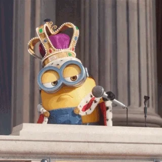A minion wearing a crown performing a mic drop after a speech.