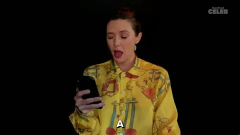 A woman looks at her phone and cries, 