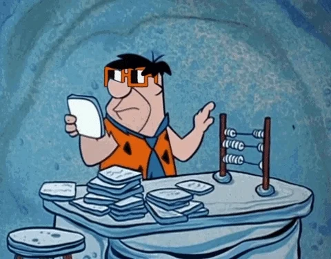 Fred Flinstone using an abacus 