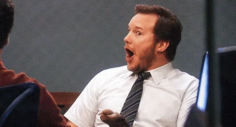 Andy Dwyer on Parks and Recreation is pleasantly surprised. His eyes and mouth are wide.