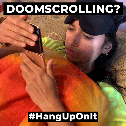 A GIF of a woman putting down her phone that says 'Doomscrolling, hang up on it.'