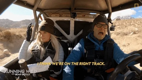 Two people in a vehicle travel through a desert. One says, 'I think we're on the right track.'
