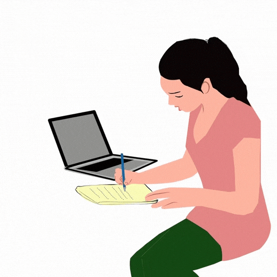 A person sitting and writing notes on a yellow notepad beside an open laptop.