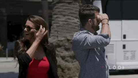 A woman and man looking around.
