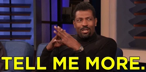 A talk show guest rubbing his hands, saying, 'Tell me more.'