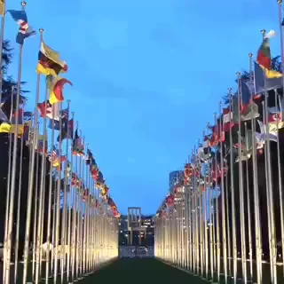 A series of world flags in front of a giant ceremonial chair in Geneva at the United Nations