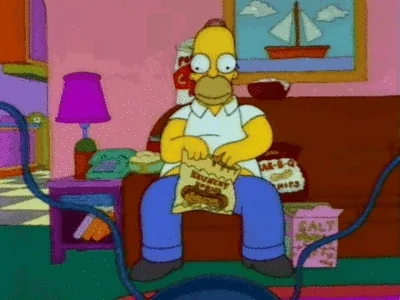 Homer Simpsons busily eating from multiple snack packets. 