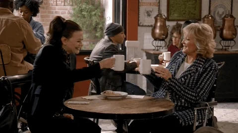 Two women hanging out in a coffee shop.