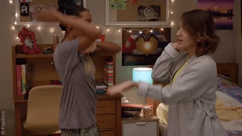 Two roommates dancing with each other