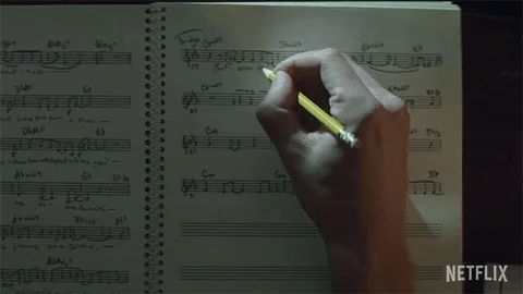 A person editing a music score by hand.