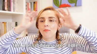 Young lady in an office waving her arms. Text reads 'The possibilities are endless'.