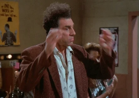 The character Kramer from Seinfeld putting his hands to his head, indicating he is overwhelmed.
