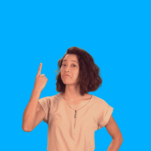 A woman nodding her head while pointing her index finger upward to the word 'fact' 