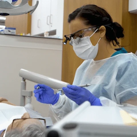 A dental hygienist working on patient.