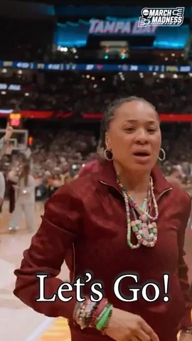 Coach Dawn Staley encourages her basketball team. She says 
