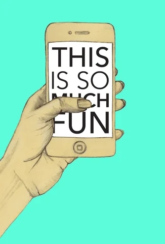 A person scrolling on a phone. The text on the screen reads, 'This is so much fun.'