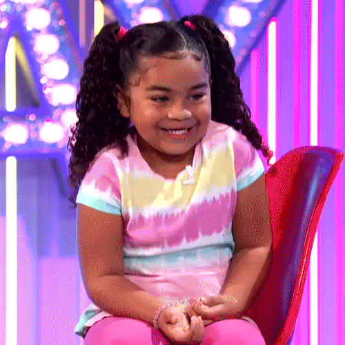 A kid clapping her hands in a game show