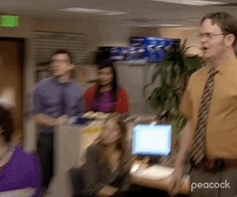 Dwight Shrute ordering his co-workers into a conference room